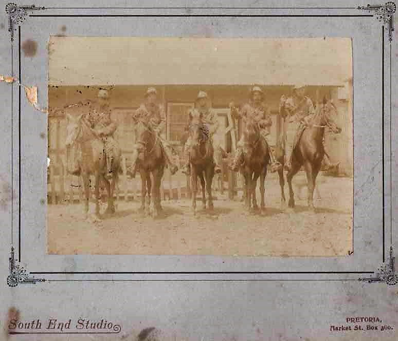 A very faded sepia photograph shows 5 mounted soldiers of the Imperial Yeomanry in Pretoria during the Anglo-Boer war
