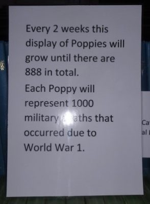 The notice says that the display of poppies is icreased every 2 weeks until there are 888 in total. Each poppy represents 1000 military deaths